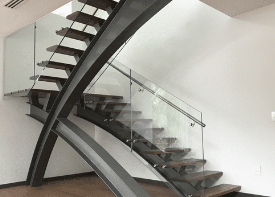 Custom modern staircase with glass railing fabricated in Miami
