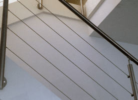 Stainless steel cable railing installed on an interior staircase