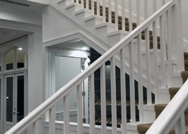 Traditional iron and wood staircase railing in a residential interior