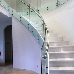Curved staircase with glass panels and stainless steel handrail